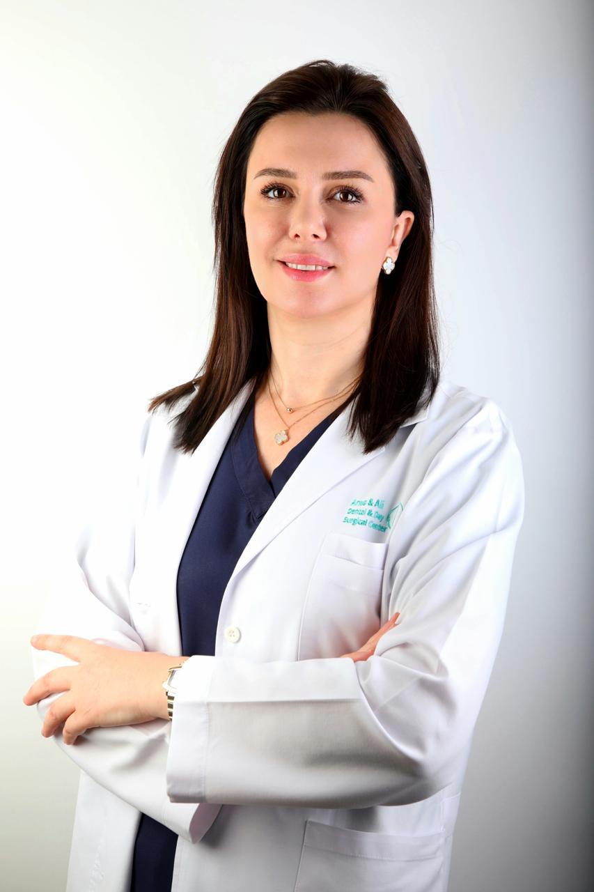 Dr. Rigerta wearing a white dental coat